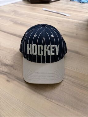 Hockey eyes without a face white and navy striped hat